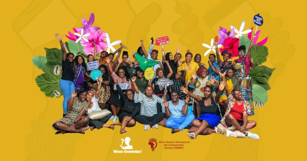 Group picture from Decolonizing the Internet: East Africa showing more than 30 African feminists and allies from the convening with their arms raised and holding up placards with feminist slogans.